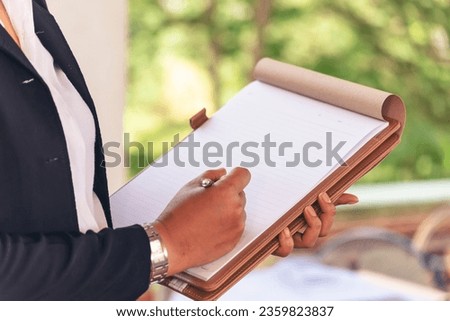 Businesswoman hands note document. Hands writing on empty notebook. Woman planning working on eco sustainable outdoors. Female hand holding pencil write on blank sketchbook. Mock-up Concept