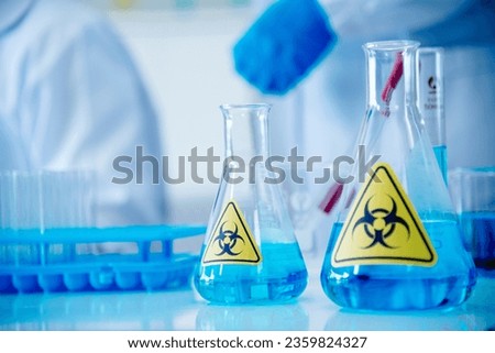 Biohazard disease alert corona outbreak sign on glass wall laboratory science center. Medical care clinic with hazard alert sign. Medical Healthcare concept. Royalty-Free Stock Photo #2359824327