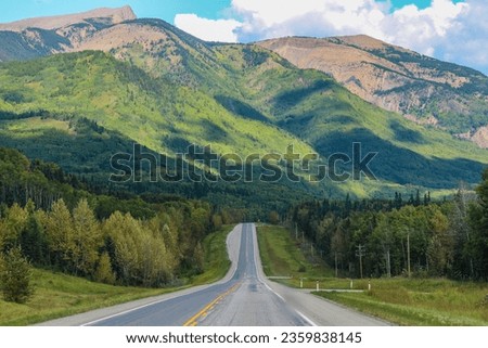 Highway scenery with mountains in background  Royalty-Free Stock Photo #2359838145