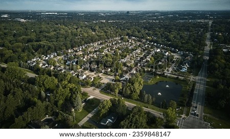 Above aerial view of residential houses and yards in suburb. Real estate photo