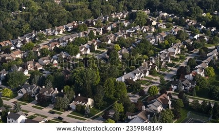 Above aerial wide view of residential houses and yards in suburb. Real estate photo