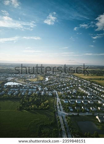 Above aerial vertical view of residential houses and yards in suburb. Real estate photo