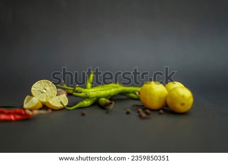 Red Chilli, lemon, garlic, ginger on black background
