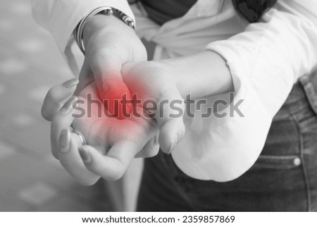 sick woman with trigger finger pain; portrait of sick asian woman suffering from trigger finger, cps, wrist joint pain, arthritis, gout, gouty pain health care concept; asian young adult woman model Royalty-Free Stock Photo #2359857869