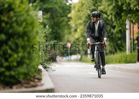 Manager commuting to the office by bike Royalty-Free Stock Photo #2359871035