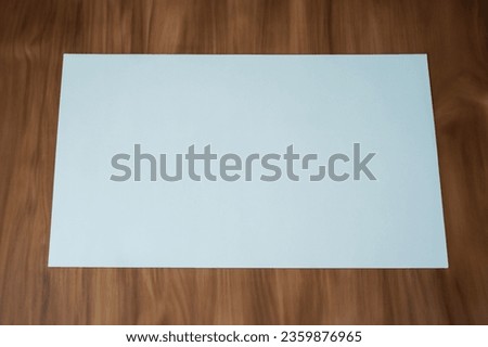 Paper on wooden table with natural feel for mockup
