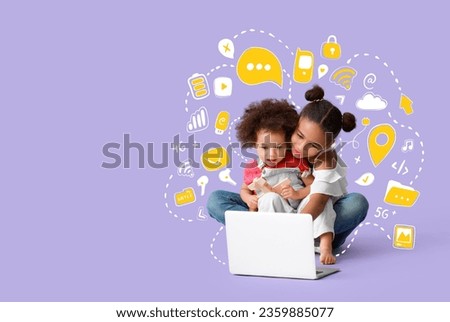 Cute African-American sisters with laptop on lilac background