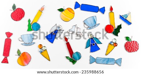 Colorful stained glass hand-made original decor items for a Christmas tree isolated on white background