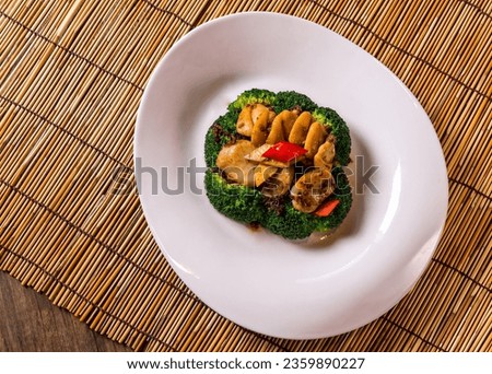 stir fried vegetable broccoli and asparagus with scallop in xo soy sauce in plate on bamboo wood table tea pot asian Chinese vegan halal food restaurant banquet cuisine menu