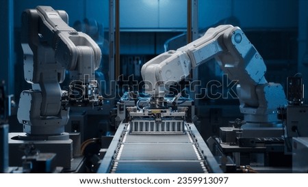 White Robot Arms on Automated EV Battery Components Production Line. Electric Car Battery Pack Manufacturing Process. Conveyor Belt on a Modern Factory. Royalty-Free Stock Photo #2359913097