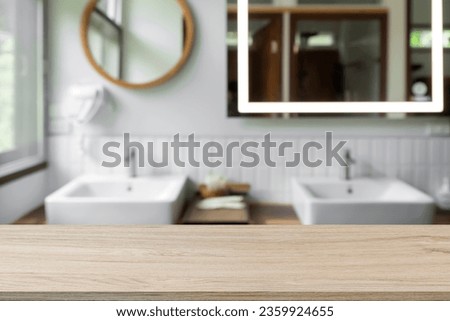Empty wooden table with blur background of lavatory or toilet. For montage products. Royalty-Free Stock Photo #2359924655