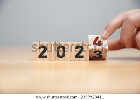 New project growth concept in 2024, Preparation for happy new year , Hand of man flip wooden cube from 2023 to 2024.
