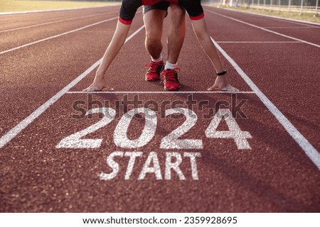 New year 2024 concept. Young man ready to run preparing for 2024 goals, Start new project. Royalty-Free Stock Photo #2359928695