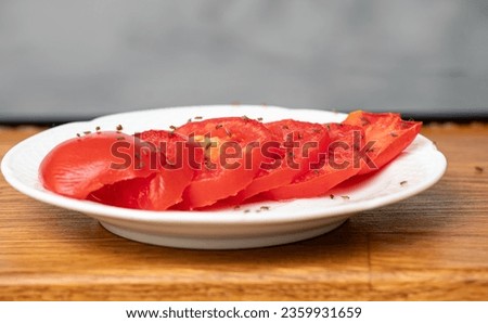 Lot of fruit flies Drosophila melanogaster eating of slices of tomatoes in home kitchen. Royalty-Free Stock Photo #2359931659