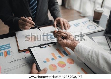 In a meeting between the finance and marketing departments to discuss work plans, two startup employees are brainstorming ideas for a profitable operating plan. Planning meeting concept. Royalty-Free Stock Photo #2359936167