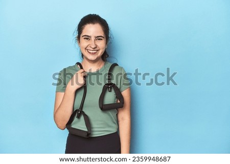 Fitness enthusiast holding a yoga mat in studio