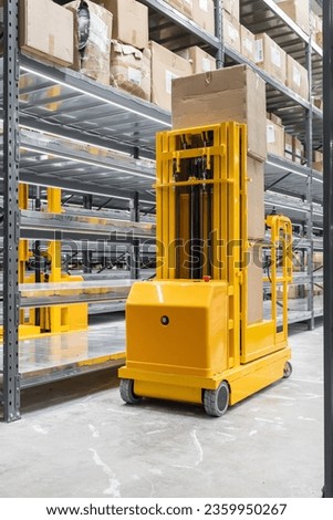 Automatic self-propelled lift in a goods warehouse Royalty-Free Stock Photo #2359950267