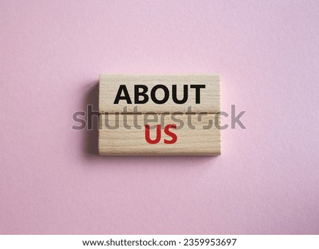 About us symbol. Concept word About us on wooden blocks. Beautiful pink background. Business and About us concept. Copy space