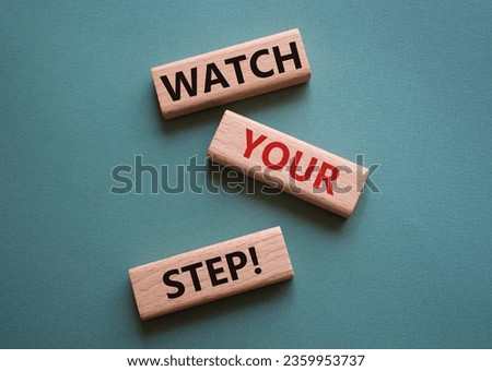 Watch your Step symbol. Concept words Watch your Step on wooden blocks. Beautiful grey green background. Business and Watch your Step concept. Copy space.