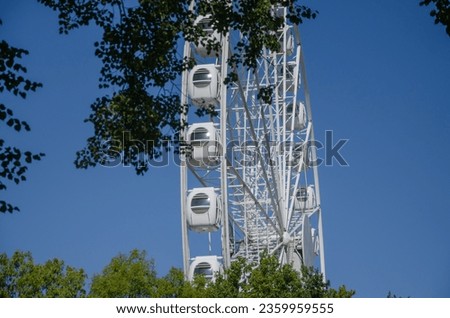 Ferris wheel against the blue sky in the park. High quality photo