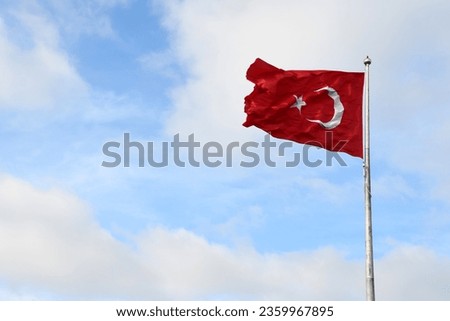 Turkish flag flying on a flagpole.