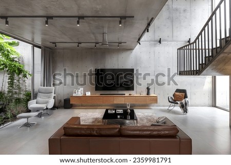 Simplicity and Elegance Merge in this Minimalist Room with Exposed Cement Wall. This room exudes a captivating blend of contemporary design and raw, industrial aesthetics. The exposed cement wall adds Royalty-Free Stock Photo #2359981791