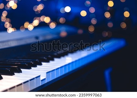 Piano keys close-up on a blurred background with bokeh. Royalty-Free Stock Photo #2359997063