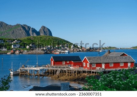 Norway. Fishermans red rorbu cottage in the Lofoten Islands. Typical Scandinavian Fishermans house. now days popular tourist apartments, cottages, rent houses. Royalty-Free Stock Photo #2360007351