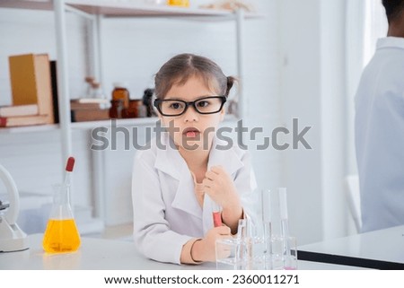 Adorable Arabian girl primary school student wearing lab coats boring unhappy studying chemical substance analyzing in laboratory room, lifestyle learning education science class for little kids