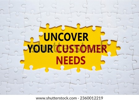 Customer Needs symbol. White puzzle with words Uncover your Customer Needs. Beautiful yellow background. Business concept. Copy space.