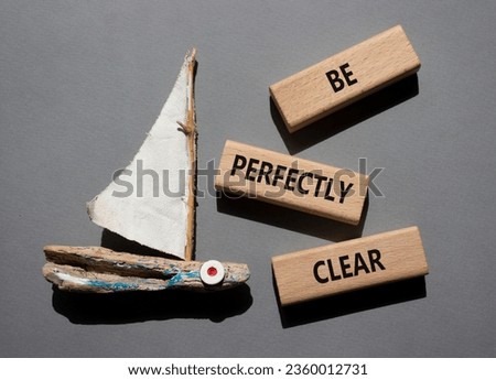 Be perfectly clear symbol. Concept words Be perfectlyclear on wooden blocks. Beautiful grey background with boat. Business and Be perfectly clear concept. Copy space Royalty-Free Stock Photo #2360012731
