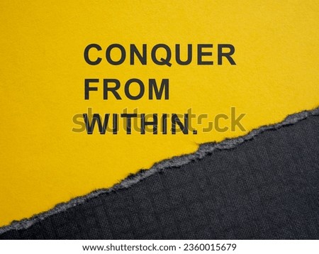 Torn piece of paper and motivation phrase conquer from within. Royalty-Free Stock Photo #2360015679