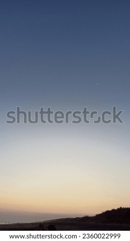 Beautiful sunset sky in beach with a mini moon