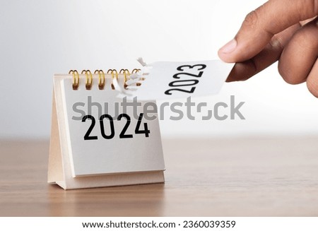 2024 Happy New year background. Turns over a calendar sheet. Setup objective target business cost and budget planning of new year concept. year change from 2023 to 2024. Royalty-Free Stock Photo #2360039359