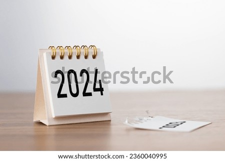 2024 Happy New year background. Turns over a calendar sheet. Setup objective target business cost and budget planning of new year concept. year change from 2023 to 2024. Royalty-Free Stock Photo #2360040995