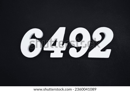Black for the background. The number 6492 is made of white painted wood.