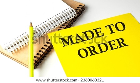 MADE TO ORDER text written on yellow paper with notebook