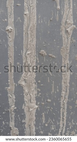Abstract background of rough cement and splashes of used cement