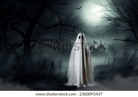 A scary ghost hiding in the forest on a full moon. Halloween background.