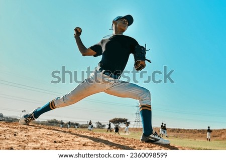 He has a strong throwing arm. Shot of a young baseball player pitching the ball during a game outdoors. Royalty-Free Stock Photo #2360098599