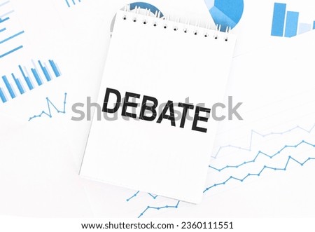 White notepad with text DEBATE on the financial documentation. Finance and business concept