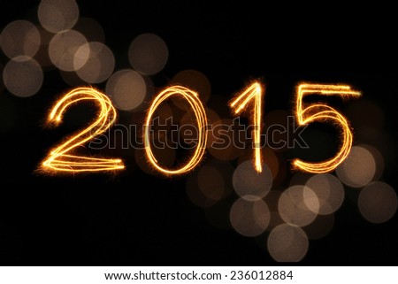 2015 written with Sparkling figures and gold blur bokeh background