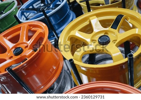 A close-up of colorful car alloy wheels in a garage Royalty-Free Stock Photo #2360129731