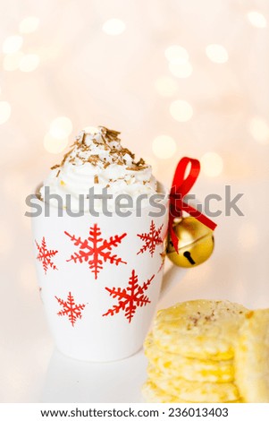 Hot chocolate garnished with whipped cream and chocolate shavings.