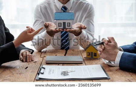 Real estate broker agent presenting and consult to customer to decision making sign insurance form agreement.