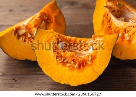 three pumpkin slices on a wooden table