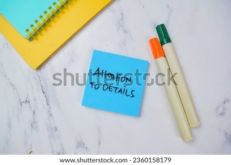 Concept of Attention To Details write on sticky notes isolated on Wooden Table.