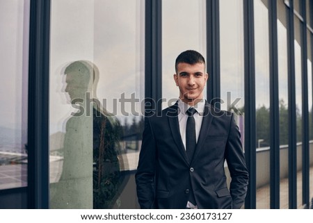 A CEO dressed in a sleek black suit stands confidently at the entrance of a modern corporate building, awaiting the start of the workday in the bustling urban environment.