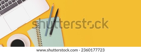 Banner with stationery, laptop and cup of coffee on a yellow background. Online education concept.