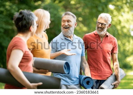 Active Retirement. Happy Group Of Senior People Walking Outdoors After Training, Sporty Mature Men And Women Holding Fitness Mats, Chatting And Laughing, Enjoying Outside Workouts, Closeup Royalty-Free Stock Photo #2360183661
